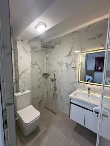 a bathroom with a toilet and a sink at Vila Sidi in Ksamil