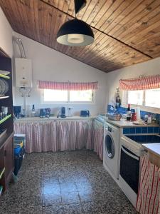 a kitchen with a washer and dryer in it at Alentempo in Aldeia de Brescos