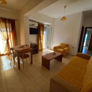 a living room with a couch and a table at Central Rooms in Makry Gialos +52 photos