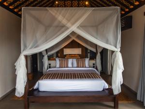 a bedroom with a bed with a canopy at Menjaga Bay in Labuan Bajo +121 photos