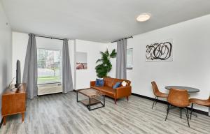 a living room with a couch and a table at The West End in Tower Grove