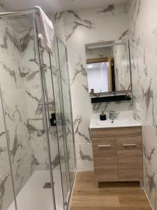 a bathroom with a shower and a sink at Apartamentos ANDASOL in Chipiona