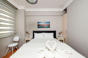 a bedroom with a bed with two white towels at Qbra House 2BR Central Apt Walk to Landmarks in Istanbul
