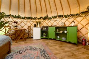 a room with a green cabinet in a yurt at Yurtshire Eavestone Lake - Willow in Ripon