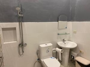 a bathroom with a toilet and a sink at Vacation Garden Home with kiddie pool, central aircon, Netflix, billiards, table tennis and karaoke in Cavite +44 photos