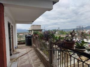 a balcony with potted plants on a building at Tales of Guwahati 1BHK - ii -AC 200 extra in Guwahati