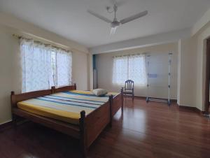 a bedroom with a large bed in a room at Tales of Guwahati 1BHK - ii -AC 200 extra in Guwahati +31 photos