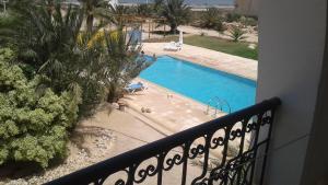 a view of a swimming pool from a balcony at Tiba Résidence in Fafou