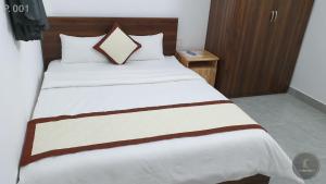 Postel nebo postele na pokoji v ubytování Vy An Hotel