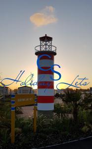 a light house with a sign in front of it at Carnaby Holiday Caravan, West Sands, Selsey in Selsey +44 photos