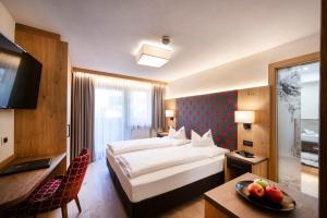 Postel nebo postele na pokoji v ubytování Wellness Hotel Gran Risa***S