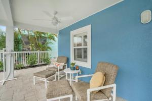 Un patio con dos sillas y una mesa y una pared azul. en 218 Primo Dr - Dolphin Beach House home, en Fort Myers Beach 12 fotos más