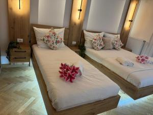 two beds in a room with towels on them at Viktor Lux Apartmani in Soko Banja