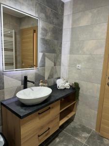 a bathroom with a sink and a mirror at Viktor Lux Apartmani in Soko Banja +33 photos