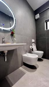 a bathroom with a sink and a toilet at Arvi Rooms in Lukovë