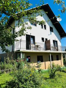 a white building with a balcony on top of it at B&B Plitvica Falls House in Plitvica selo