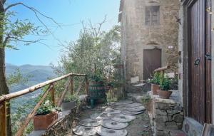 a stone house with a balcony with plants on it at C'era Una Volta In Mlaterone in Montelaterone +17 photos