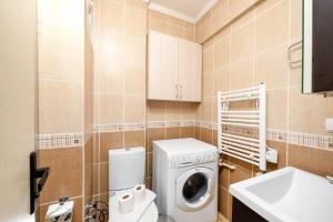 a small bathroom with a washing machine and a sink at Qbra House 2BR Central Apt Walk to Landmarks in Istanbul