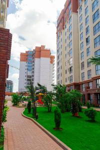 a park in a city with tall buildings at Greyscape Apple Tree Apartment in Nairobi +26 photos