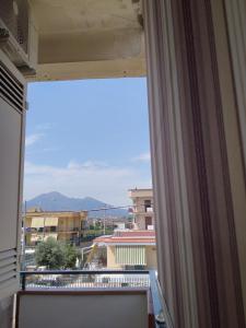 a window with a view of a city at Turisti a Casa mia in Santa Maria La Carità +17 photos