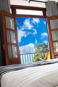 a bedroom with a window with a view of the sky at Different View in Ella