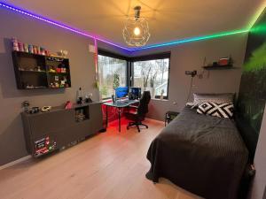 a bedroom with a bed and a desk with a computer at Large pool villa, roof terrace near lake & nature in Floda +38 photos