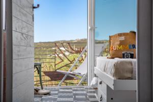 a room with a balcony with a view of a chair at Lu Gamasinu di Ziu Vittorio in Santa Teresa Gallura +4 photos