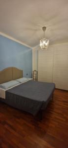 a bedroom with a large bed and a chandelier at Girasole in Vittorio Veneto