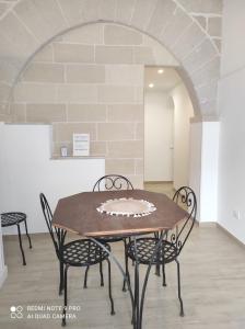 a table and chairs in a room with a brick wall at Le Dimore Di Gianni centro in Favignana +38 photos