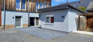 a white house with a driveway in front of it at Wohnung 1 Tollgauer in Zennern