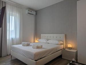 Ένα ή περισσότερα κρεβάτια σε δωμάτιο στο Catullo Stay Near The Airport