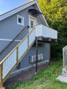 a house with a staircase leading up to a porch at Loftet in Insjön