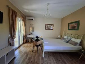 a bedroom with a bed and a table in it at Actis studios 2 in Stelida