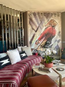 a living room with a couch and a painting on the wall at Marbella Boutique Art suites in Marbella