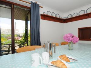 a blue table with croissants and flowers on it at West Lee in Bude