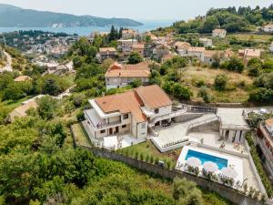 an aerial view of a house with a swimming pool at Albizia in Herceg-Novi