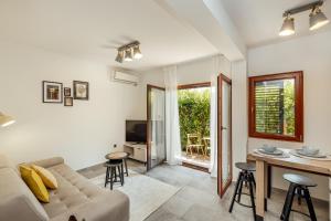 a living room with a couch and a table at Albizia in Herceg-Novi