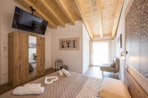 a bedroom with a bed with two towels on it at Fienile Nonna Elide in Altivole