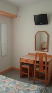 a room with a desk with a mirror and a chair at Maison Jean le Bon in Dax