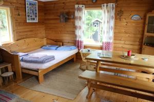 a bedroom with a bed in a log cabin at Cozy Cabin by the Lake in Gennarby