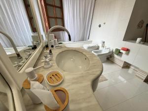 a bathroom with a sink and a toilet at Appartamento villa Francesca in Castelluzzo