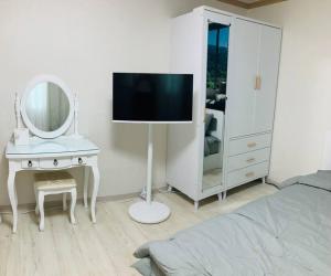 a bedroom with a bed and a dresser with a mirror at 1 min from Sadang Station line 2 & 4 in Seoul