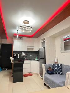 a living room with a couch and a red ceiling at Avida Towers Riala Tower inside IT Park Cebu City in Cebu City