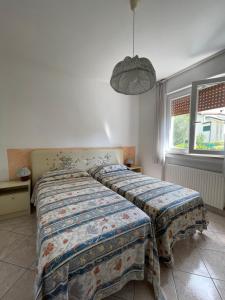 Postel nebo postele na pokoji v ubytování Residence Cascata Varone