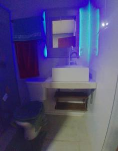 a bathroom with a white sink and a toilet at Residêncial CostaClara in Rio Verde +3 photos