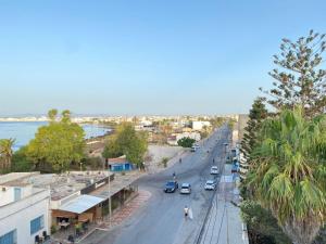 a city street with cars parked on the side of the road at Dar zman in Kelibia