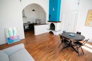 a living room with a table and a couch at Il colibrì in Pescara