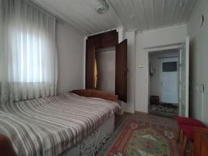 a bedroom with a bed with a window and a rug at Afyon kalesi eteklerinde bir yer in Afyon