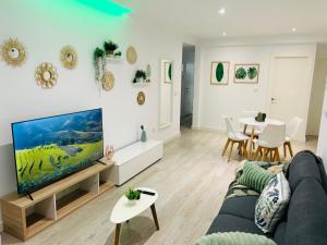 a living room with a couch and a tv at Deluxe Familiar in Albacete