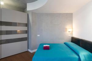 Un dormitorio con una cama azul con una caja roja encima. en Domus DiDio, en Roma
